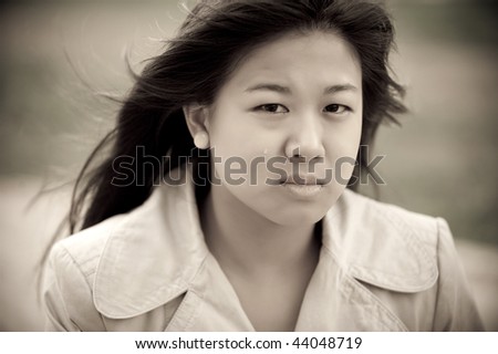 Young asian girl crying. Tears in her face