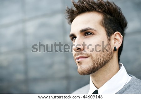 stock photo : Young handsome man close portrait (piercing in ear and lips)