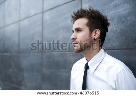 stock photo : Young handsome man looking thoughtful (piercing in ear)