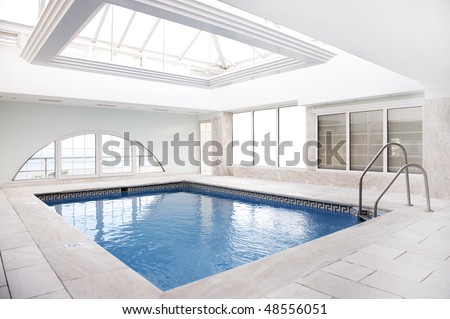 Luxury swimming pool with lot of windows.
