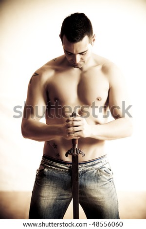 Man with sword in studio shoot.