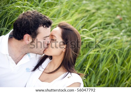 Happy couple kissing in nature