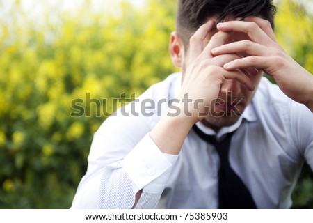 Businessman in depression with hands on forehead