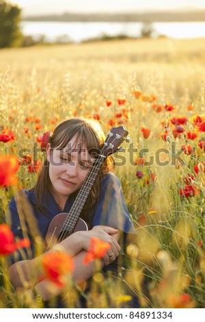 Young beautiful woman playing music outdoors