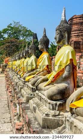 Row of ruined statue of buddha at Wat Yai Chaimongkol, Ayuthaya, Thailand.
