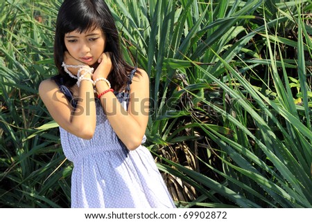 Young asian woman thinking about something outdoor