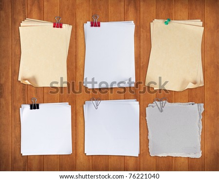set of paper with clip over wood pane