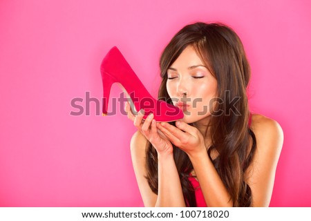 Woman Kissing Shoe. Women Loves Shoes Concept. Multiracial Girl And Pink High Heels Shoes On Pink Background. Beautiful Young Happy Mixed Race Asian Chinese And Caucasian Female Model.