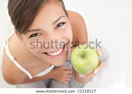 Apple woman holding green apple. Beautiful smiling young woman. Beautiful natural smiling healthy looking young woman.