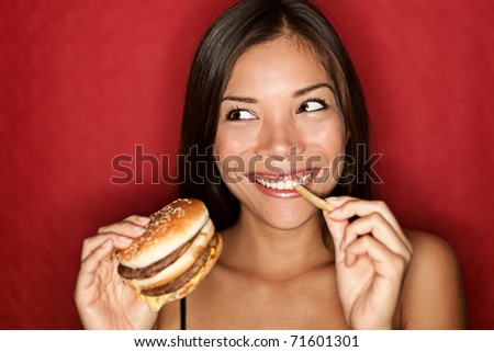 fat person eating burger. stock photo : Woman eating