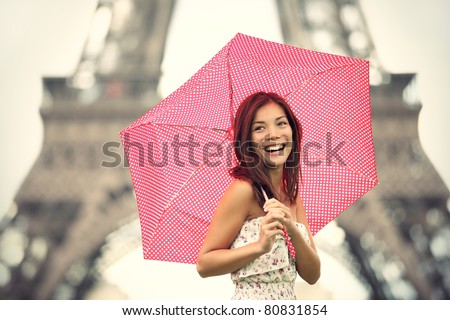 Paris Eiffel Tower Woman happy smiling in front of tourist attraction Eiffel Tower. Joyful fresh Caucasian Asian girl laughing.