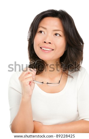 stock photo Thinking middle aged mature Asian woman looking up at copy 