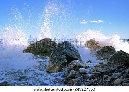 Sea surf with stones and water splashes