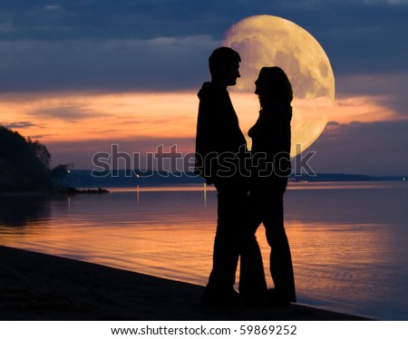 Romantic mood and couple and huge Moon behind