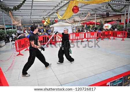 TURIN - NOVEMBER 25: Duel with the laser swords during the exhibition of games at the gathering GiocaTorino in Lingotto, on November 25, 2012 Turin, Italy.