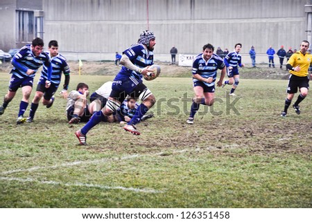 TURIN - JANUARY 27: Unidentified player of the Amatori Parma team runs toward the goal line during the rugby match between Cus Torino and Amatori Parma, on January 27, 2013 Turin, Italy.