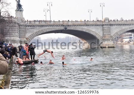 TURIN - JANUARY 27: The challenge plunge of the people named polar bears into the cold winter waters of river Po, a traditional annual event that starts the new year, on January 27, 2013 Turin, Italy.