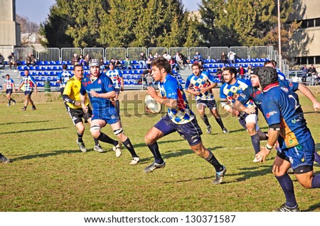 TURIN - MARCH 3: Unidentified player of the Cus Torino team runs toward the goal line during the rugby match between Cus Torino and Rugby Paese , on March 3, 2013 Turin, Italy.