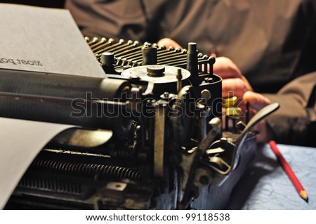 Really old typewriter. Writer in action.