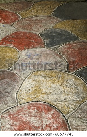 A path made of large flat stones of different colors.