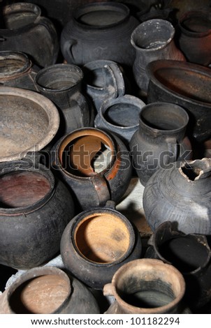Lots of old clay black pots on floor