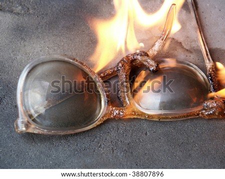 Burning old plastic rim spectacles