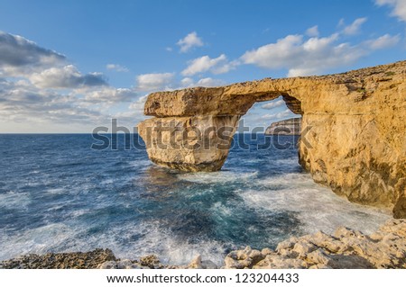 Azure Window natural arch featuring a table-like rock over the sea in the Maltese island of Gozo.