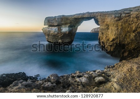 Azure Window natural arch featuring a table-like rock over the sea in the Maltese island of Gozo.