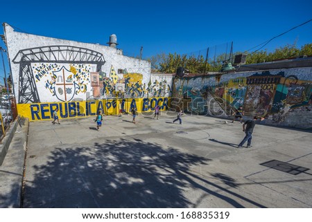 BUENOS AIRES, ARGENTINA - APR 12: People playing football near the colorful houses of Caminito street in La Boca on Apr 12, 2013 in Buenos Aires, Argentina.