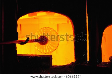 Melting glass inside an oven at Murano glass factory located at Murano Island, Italy