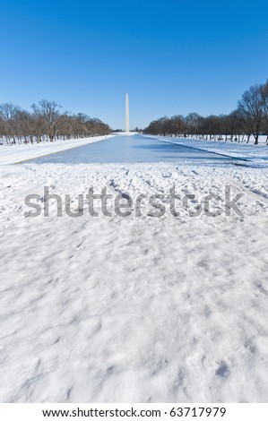 The Washington Monument and the Reflecting pool after a snow blizzard at the Mall in DC, USA