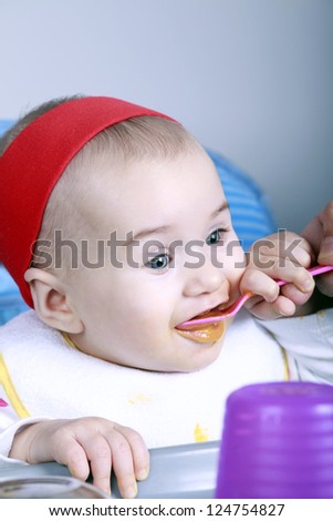 Happy baby eat with spoon