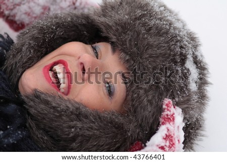 Laugh Woman Laying on the Snow