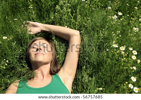 Young Woman resting on meadow. Summer relax