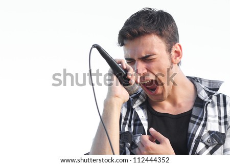 Young rocker singing expressive Isolated on overexposed white sky outdoors Young rocker singing expressive Isolated on overexposed white sky outdoors