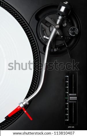 Professional DJ audio equipment - turntable needle on white vinyl record shot from above