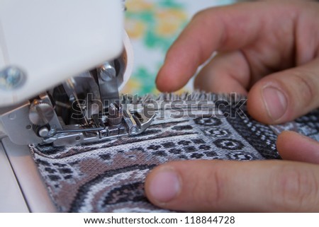 Closeup details of tailors work on a sewing machine. This is how handmade clothes are made at home.
