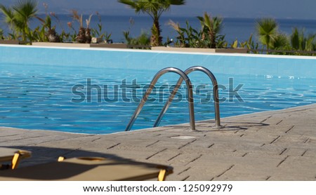 Railing of the clean shiny swimming pool outdoors