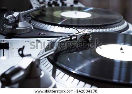 Professional sound equipment for a disc jockey. Turntable vinyl record players and 2 channel sound mixing controller.