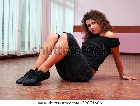 Girl taking a rest on the floor in the dance-class after work-out