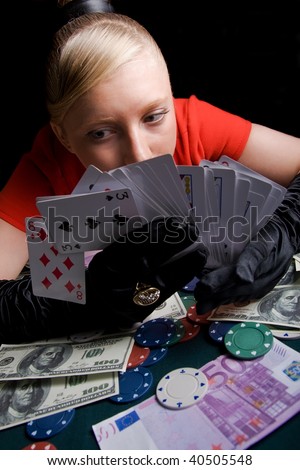 Blond girl holding bunch of playing cards