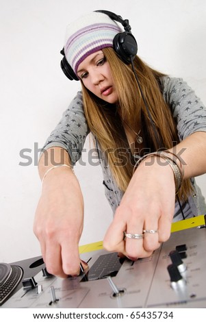 Young girl mixing music on professional mixing controller device
