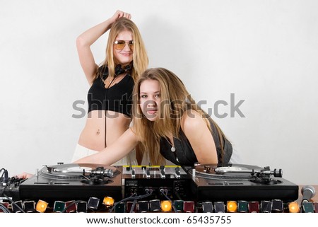 Couple of pretty chicks playing music from a vinyl record