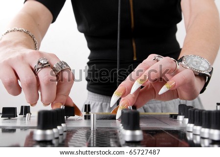 Girl mixing two tracks on professional audio mixing controller