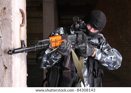Photos of heavy equipped soldiers or terrorists in black masks with automatic guns.