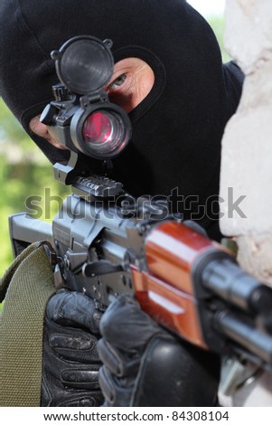 Photos of heavy equipped soldiers or terrorists in black masks with automatic guns.