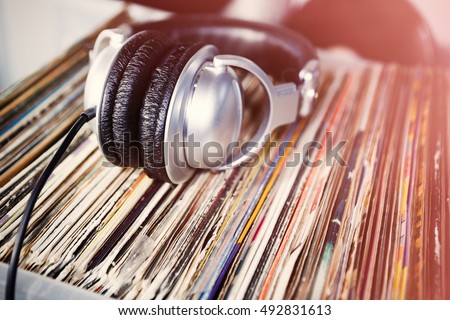 Collection of vinyl records for DJ, music lover, hipster. Listen to analog record in headphones. Analog audio equipment.Head phones for disc jockey