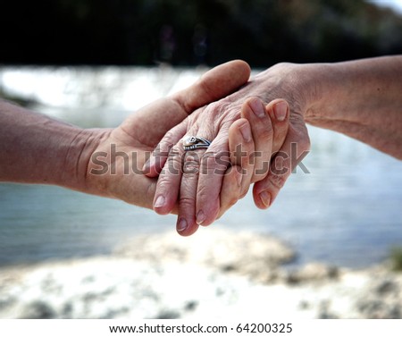 Young hand supporting old hand-helping elderly people concept
