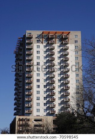 Many-storied apartment (condo) building on blue sky background