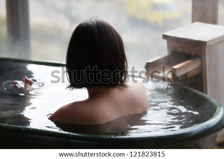 Woman enjoys bath at hot springs in Japan